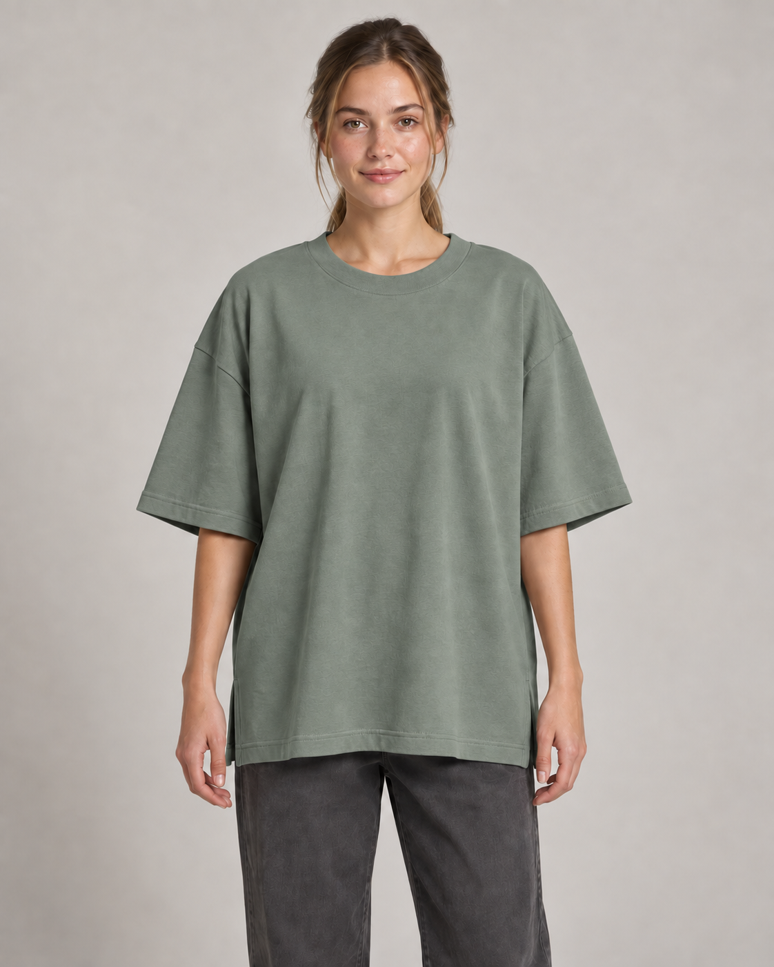 Generated concept mockup: Women's Still Oversized Tee in Eucalyptus, front view on model.