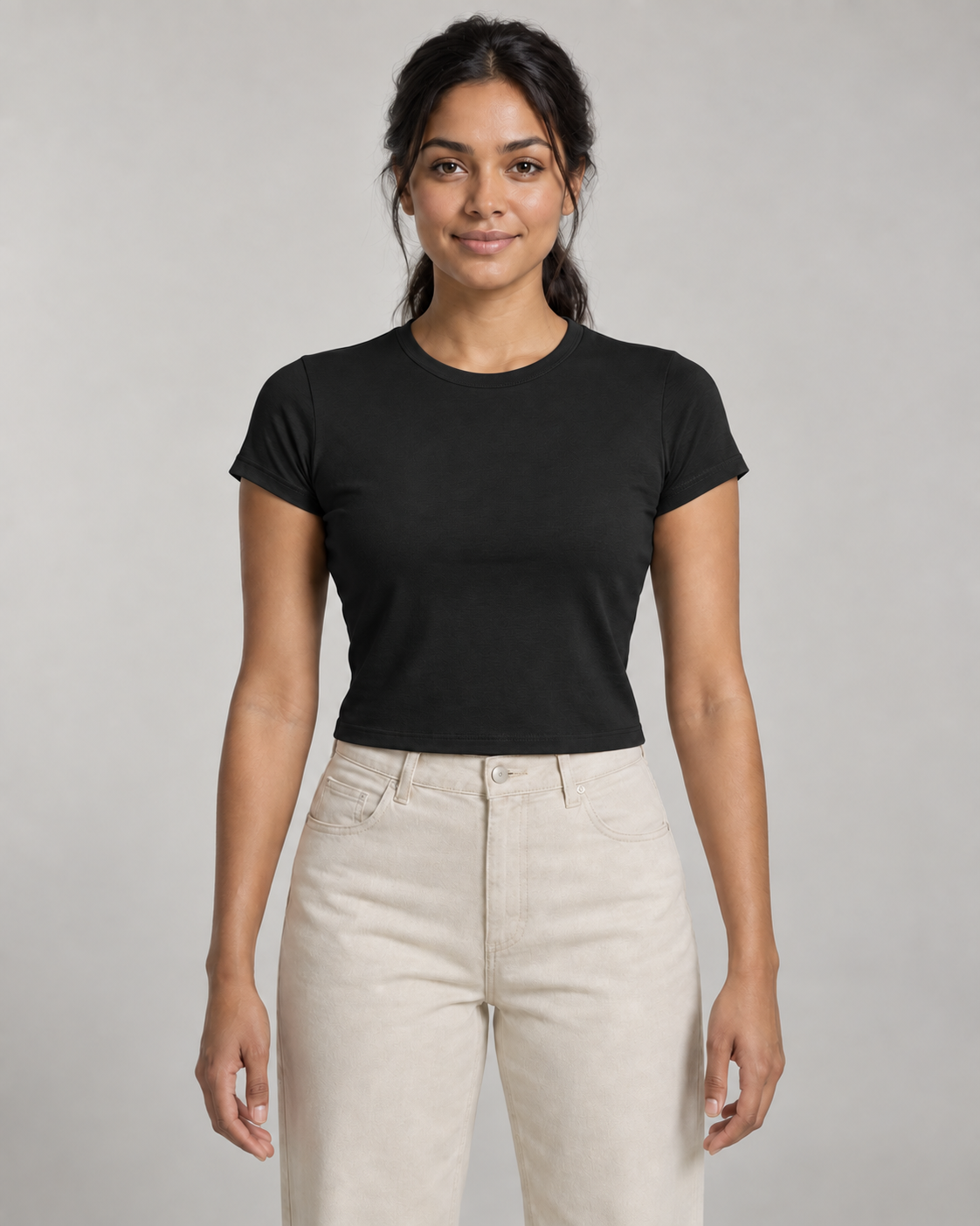 Generated concept mockup: Women's Balance Baby Tee in Black, front view on model.