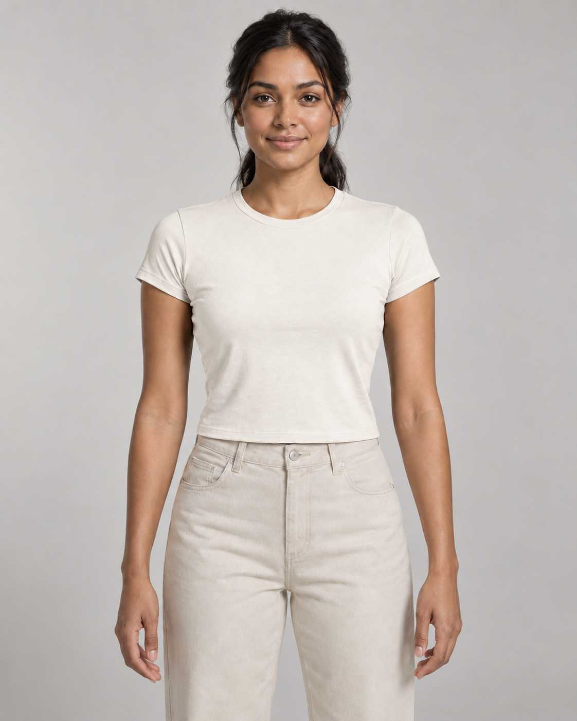 Generated concept mockup: Women's Balance Baby Tee in Chalk, front view on model.