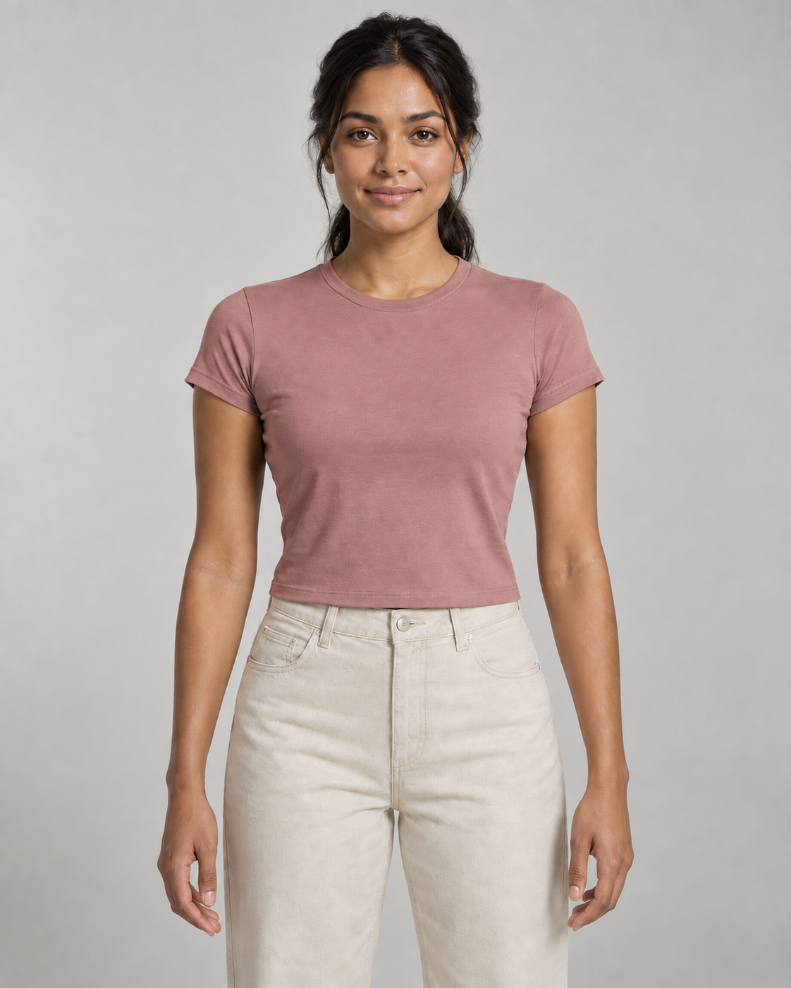 Generated concept mockup: Women's Balance Baby Tee in Dusty Rose, front view on model.