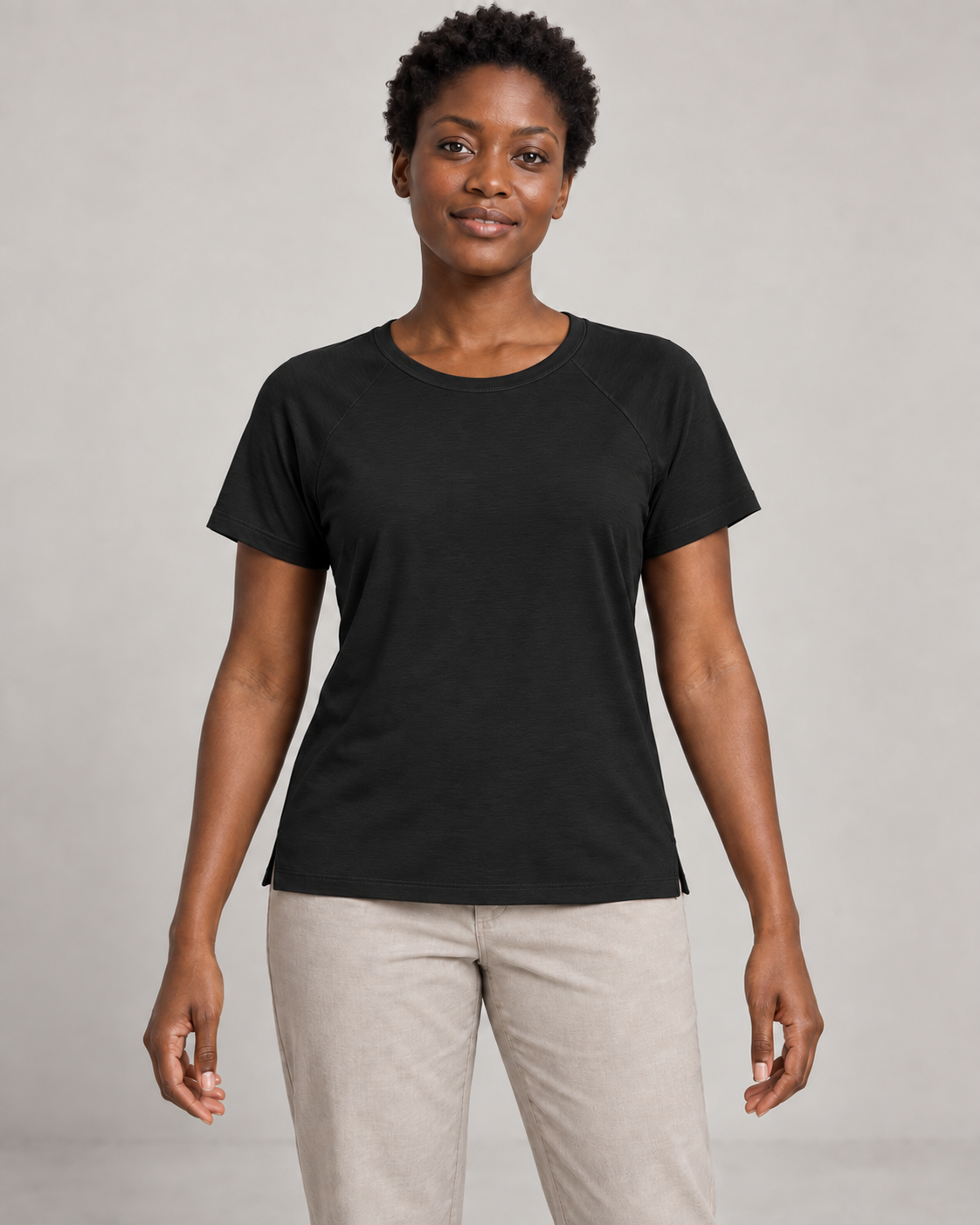 Generated concept mockup: Women's Cadence Raglan Tee in Black, front view on model.