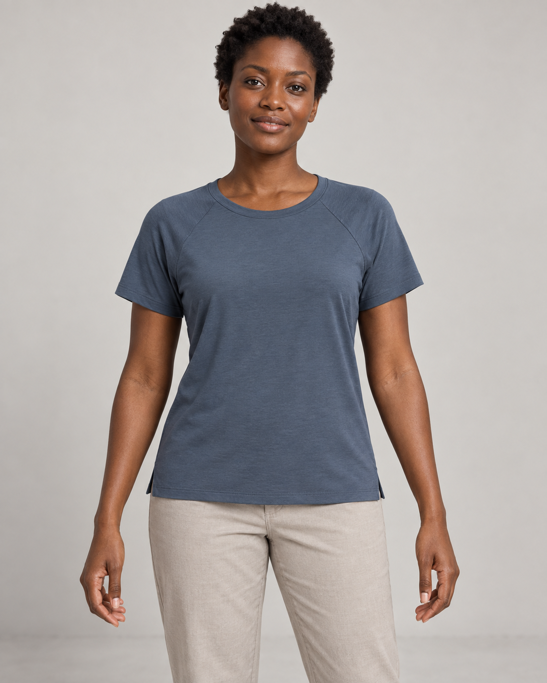 Generated concept mockup: women's Cadence Raglan Tee in Slate, front view on model.