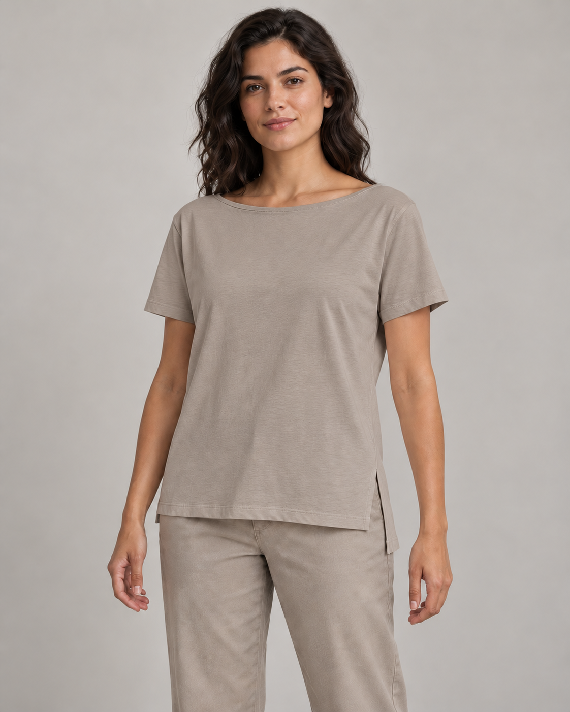 Generated concept mockup: Women's Linea Split-Hem Tee in Stone, front view on model.