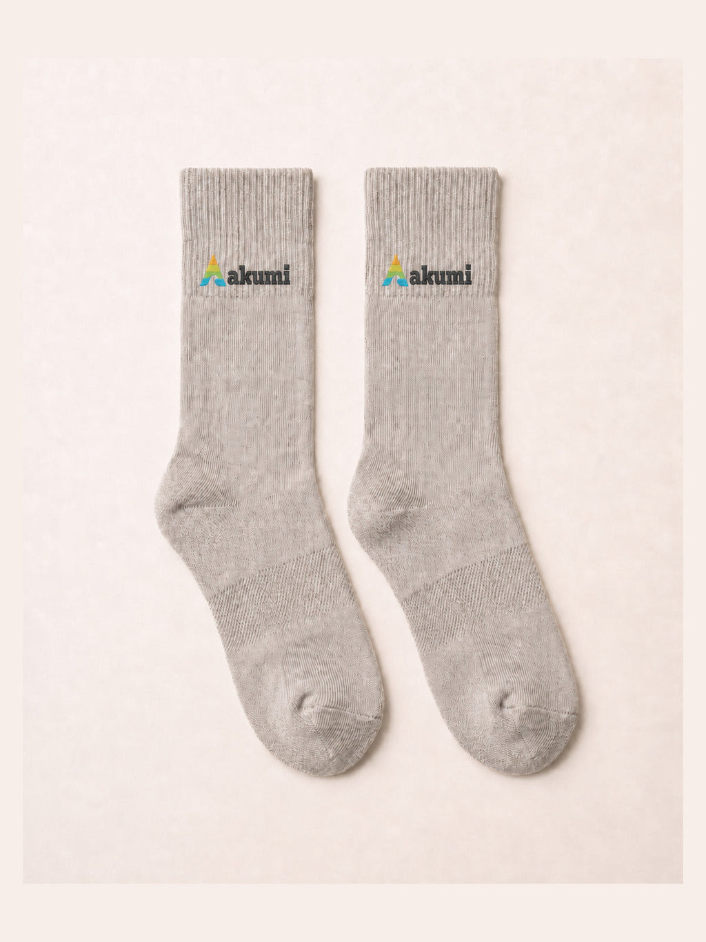 Akumi Balance Mid-Crew Sock in Mineral with corrected raised embroidered Akumi wave logo, flat lay