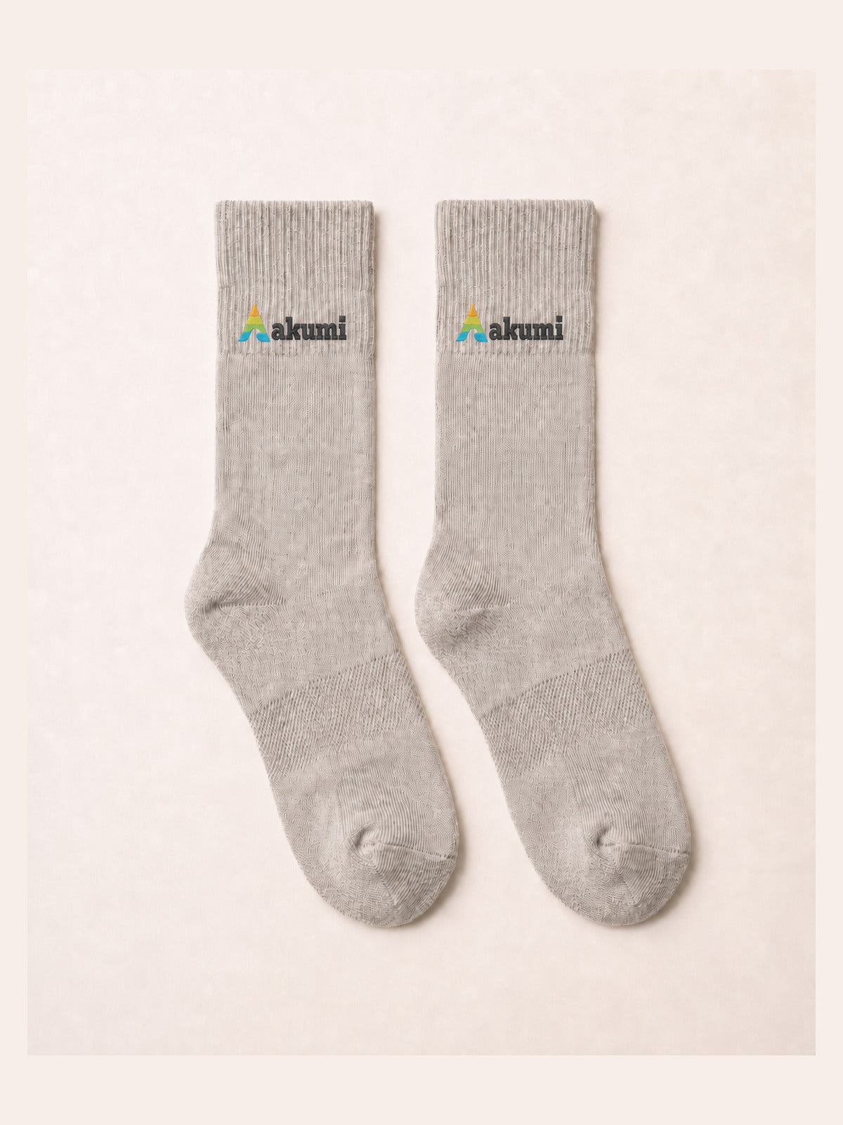Akumi Balance Mid-Crew Sock in Mineral with corrected raised embroidered Akumi wave logo, flat lay