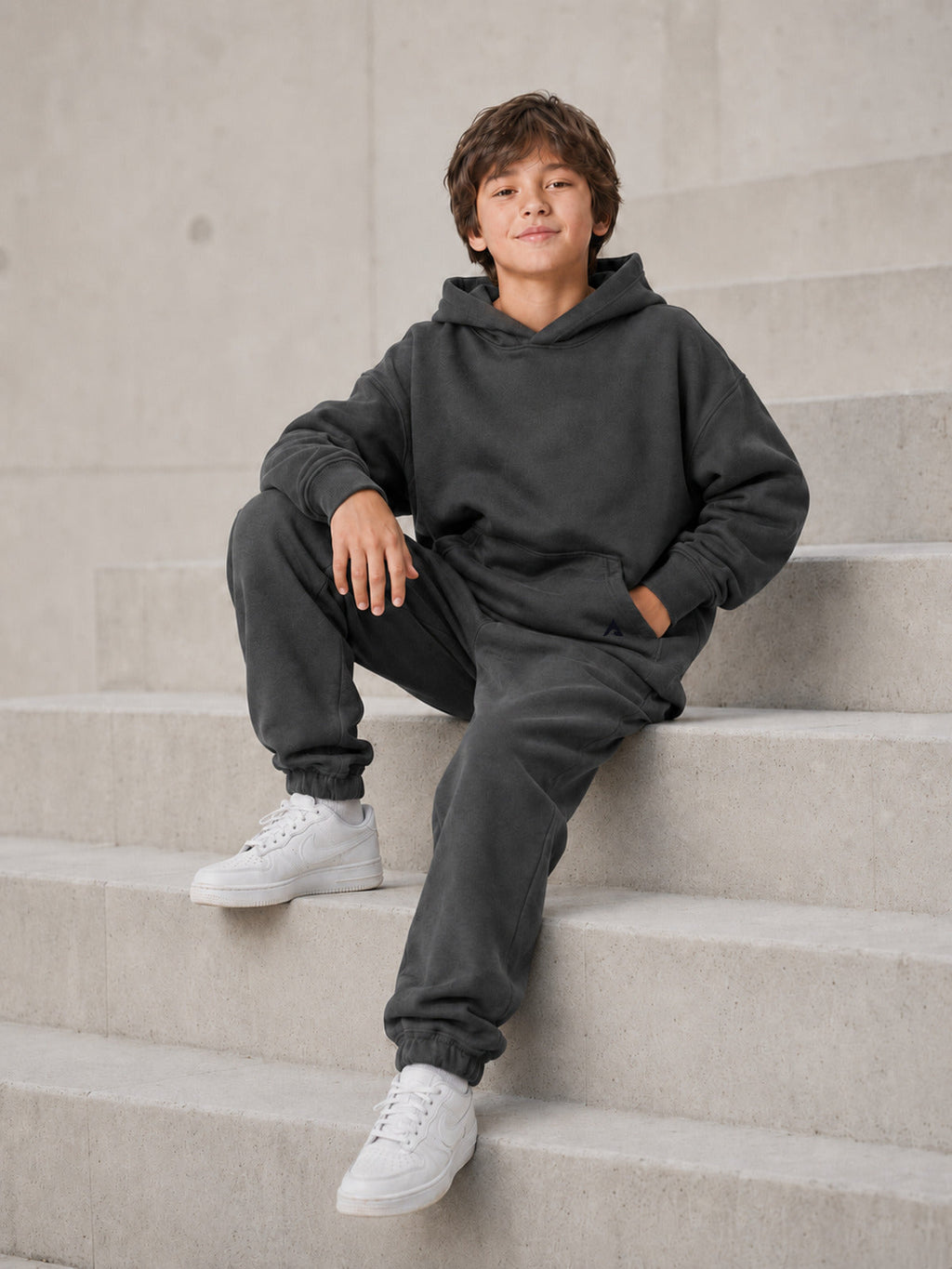Stillform Kids Hoodie seated lifestyle view