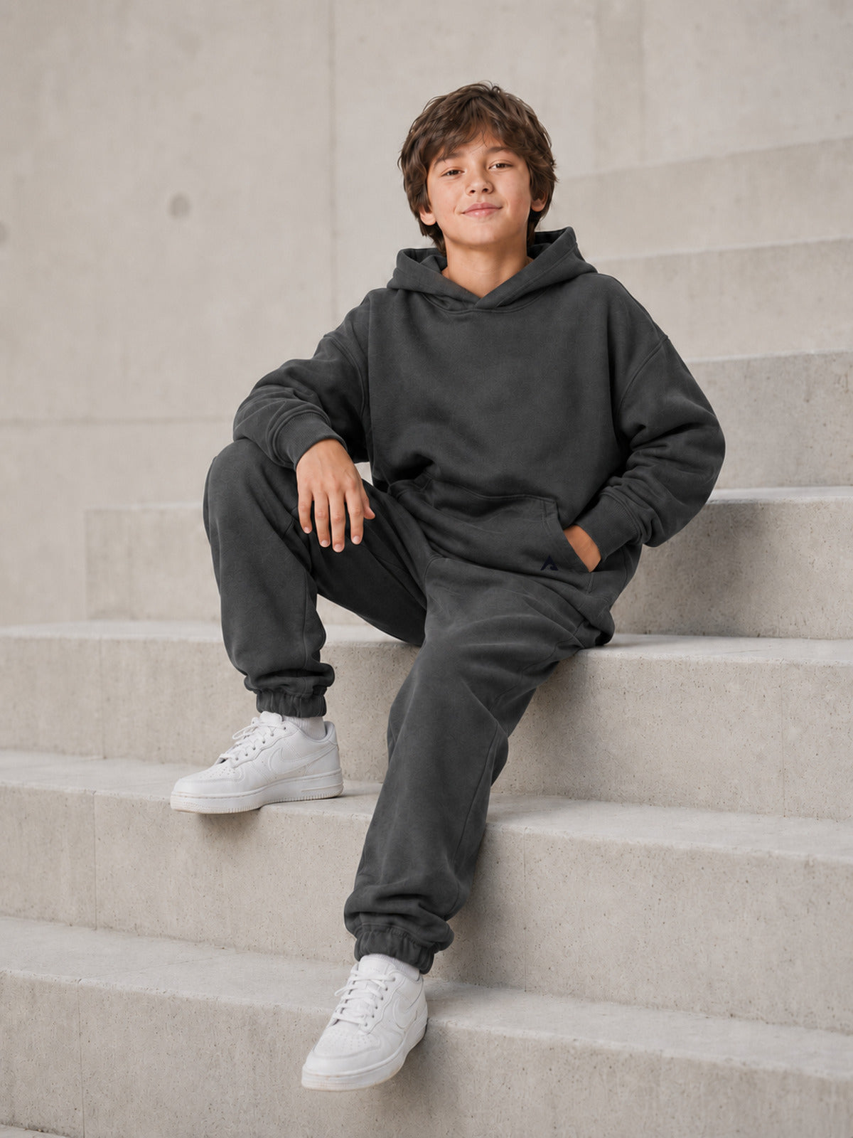 Stillform Kids Hoodie seated lifestyle view