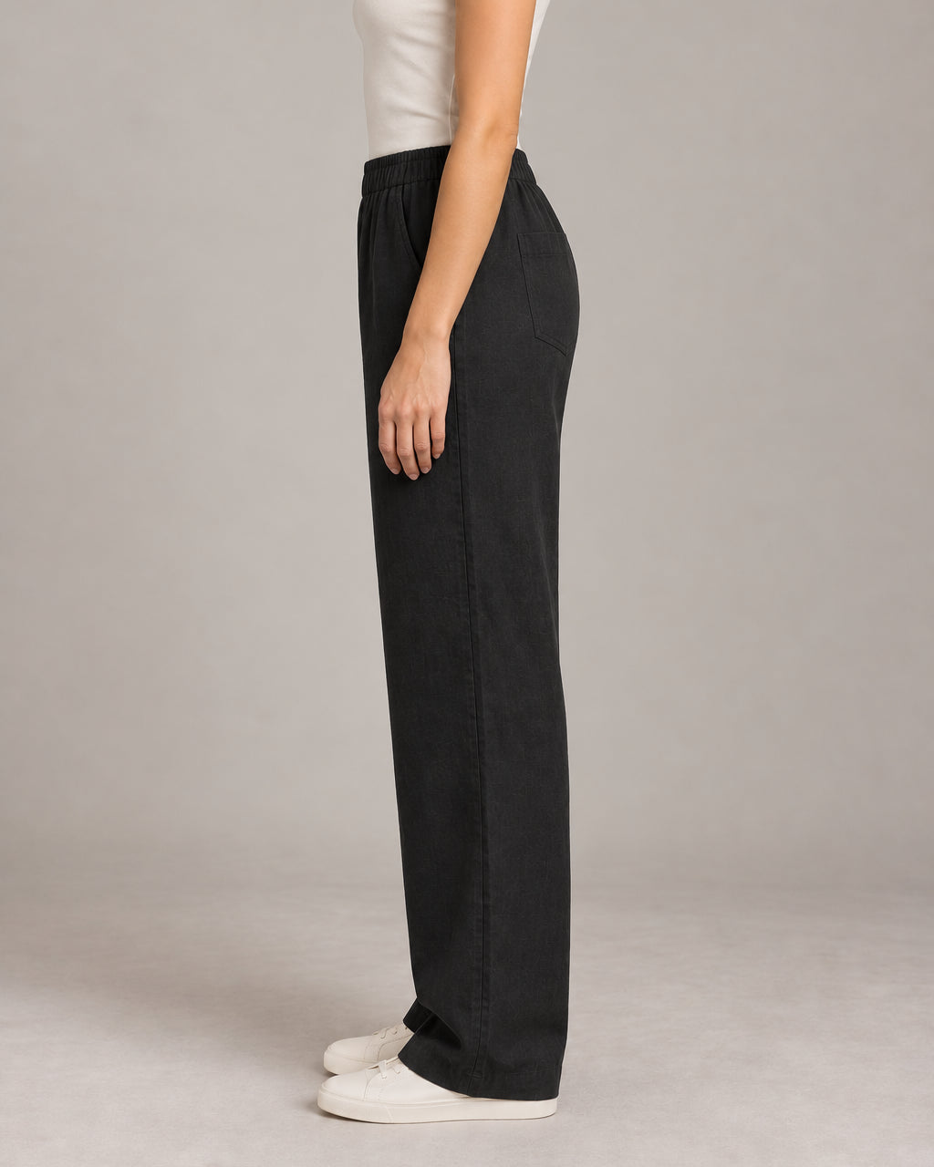 Generated design concept: Akumi Women's Coast Drawcord Woven Pant in Onyx, left side studio view. Proposed construction, not a verified product photograph.
